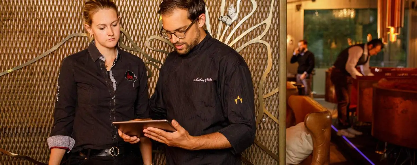 restaurant staff looking at restaurant tech